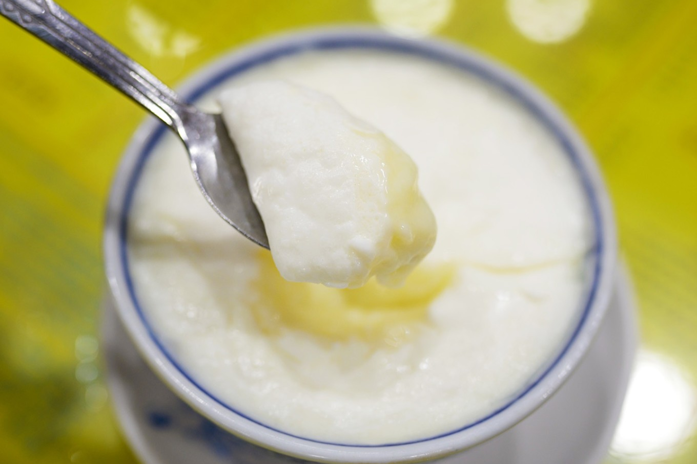  A bowl of classic double-skin milk, perhaps with a spoon