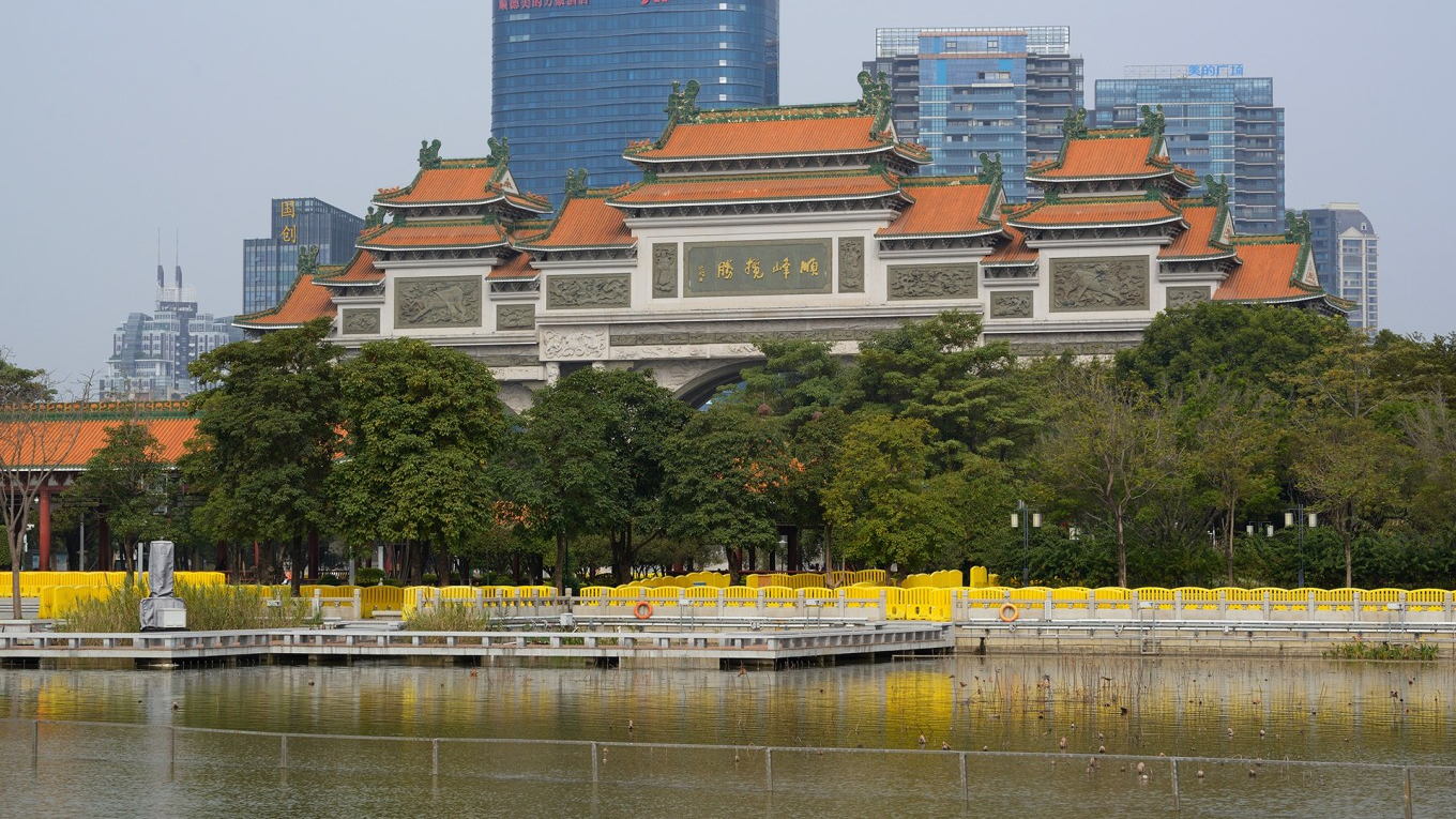  A serene lake scene within Shunfengshan Park, perhaps with a bridge or pavilion