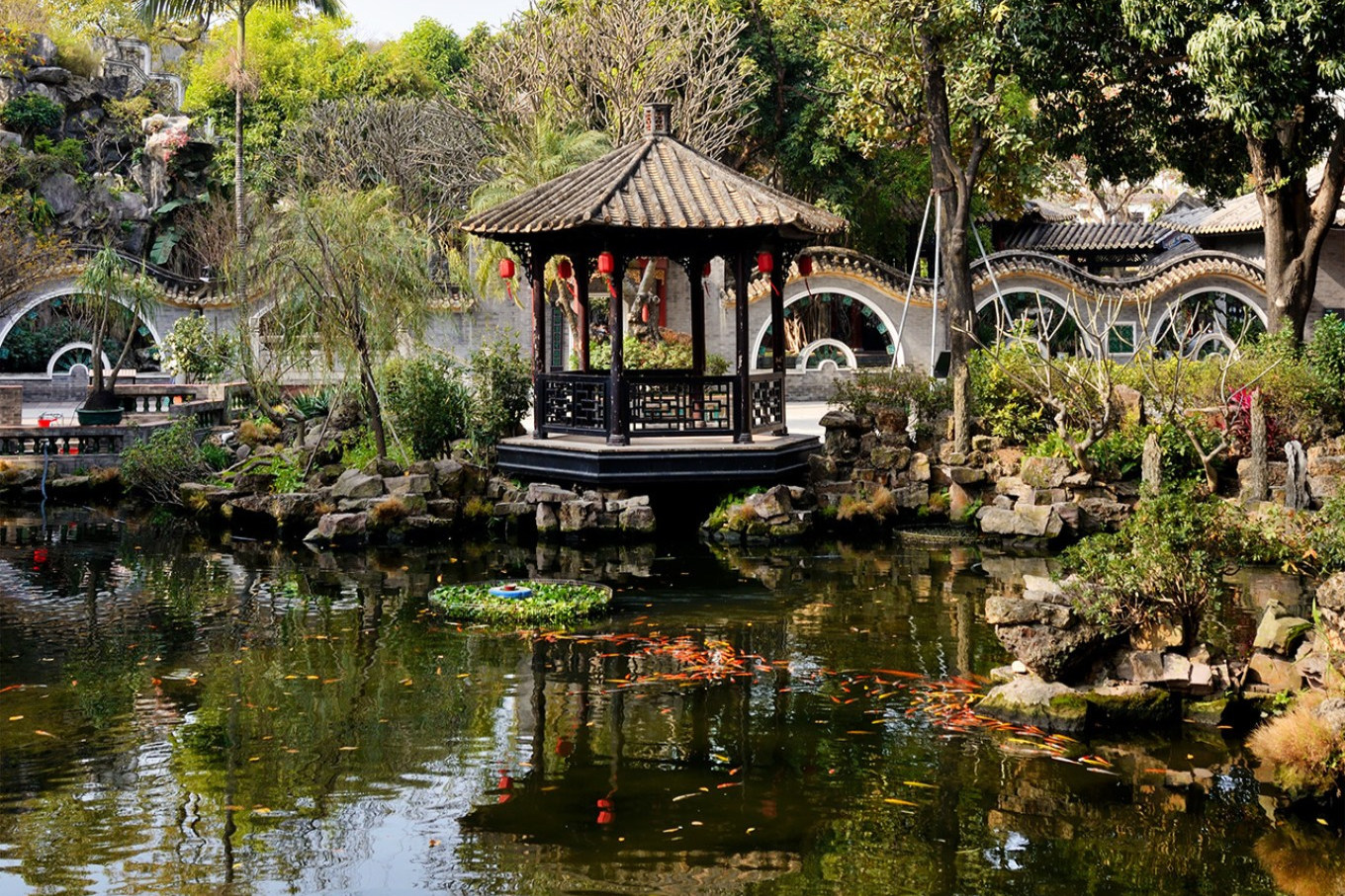  A tranquil pond scene with reflections of pavilions and greenery in Qinghui Garden