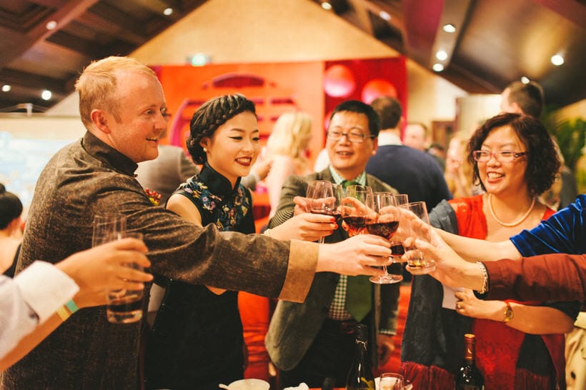 Business banquet scene with toasting and food sharing