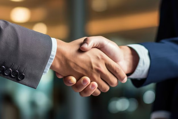 Business people shaking hands in formal setting