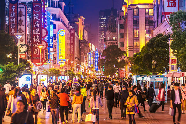 Busy street scene in China with neon signs and crowds