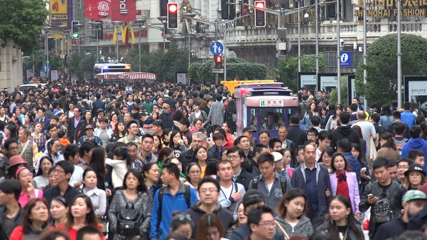 Crowded Chinese street scene showing typical public behavior