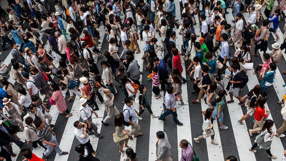 Crowded public space in China with people using smartphones