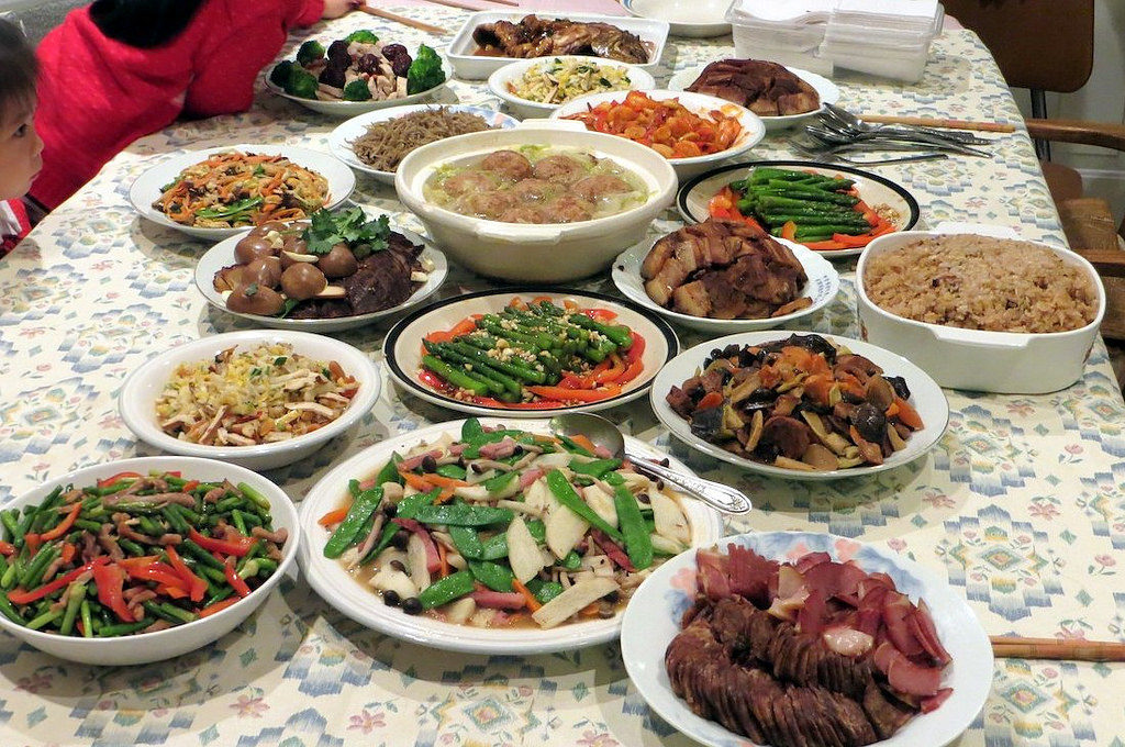 Family-style Chinese meal with lazy Susan and shared dishes