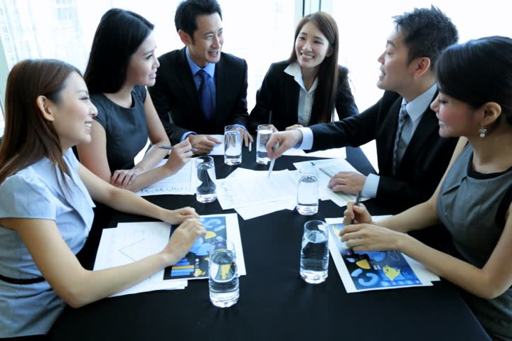 Group of business people having a harmonious meeting