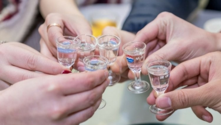Group toast at a Chinese banquet with baijiu glasses