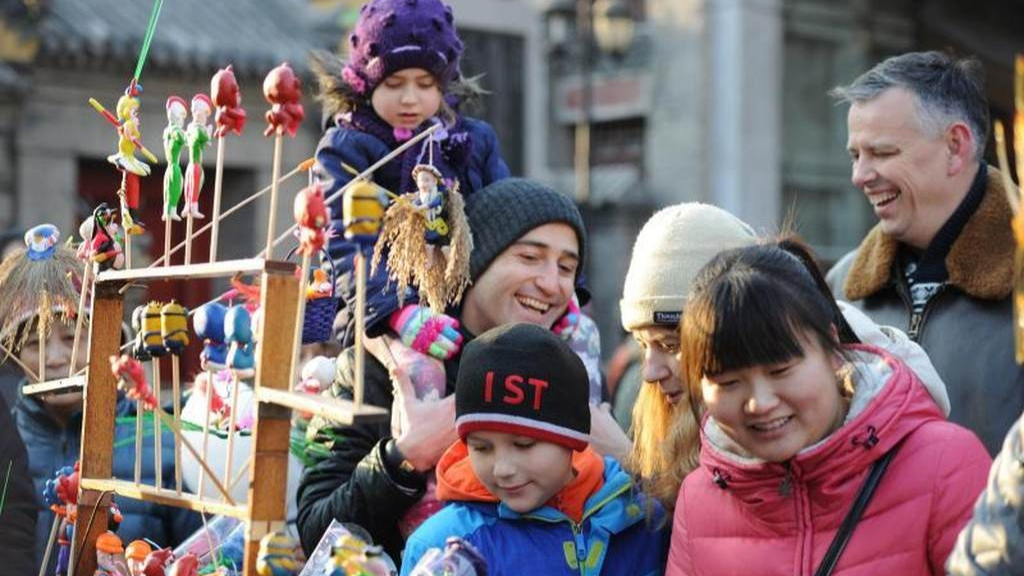 Happy tourist interacting with locals in a Chinese market