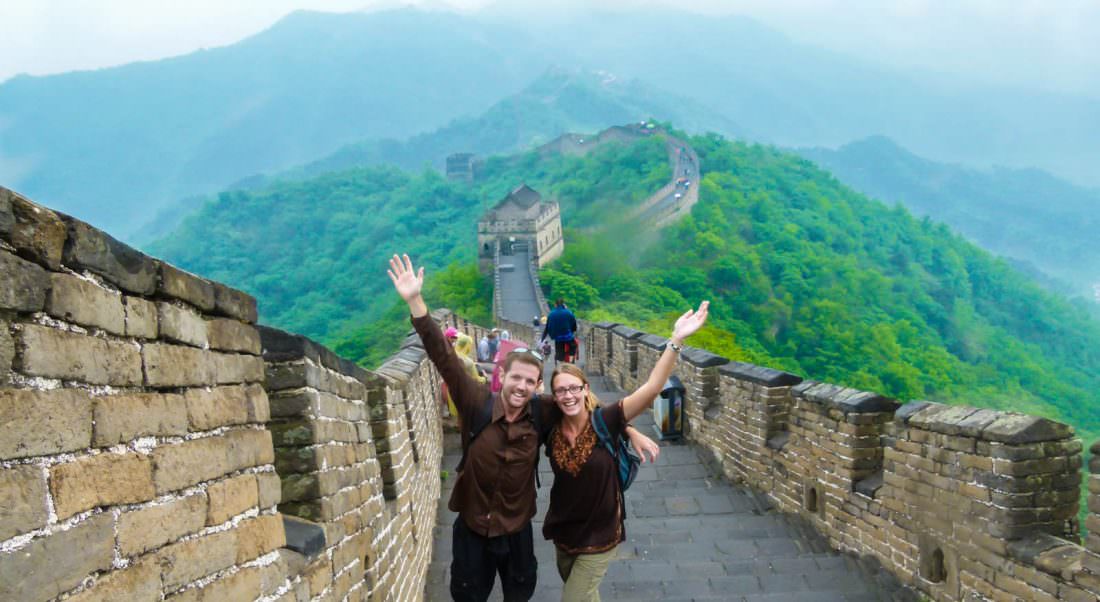Happy tourists taking photos at the Great Wall of China