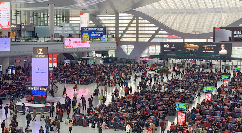 Large modern high-speed rail station in China with many passengers