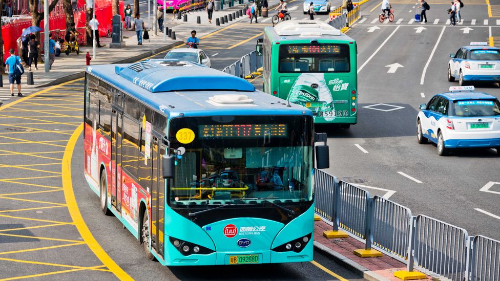 Modern electric buses on a busy Chinese city street