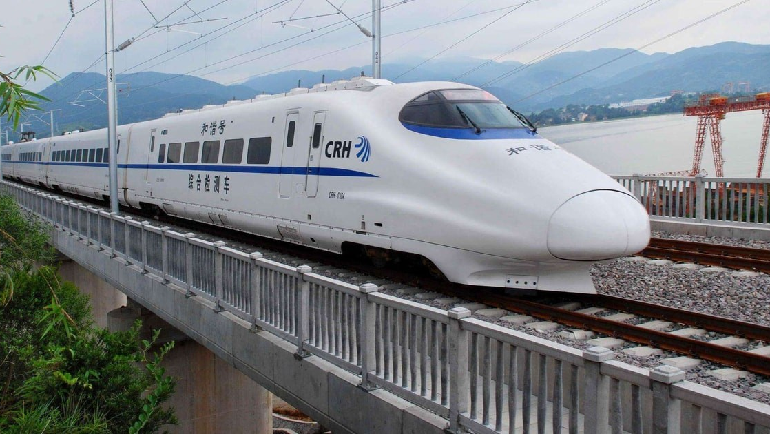 Modern high-speed train traveling through Chinese countryside