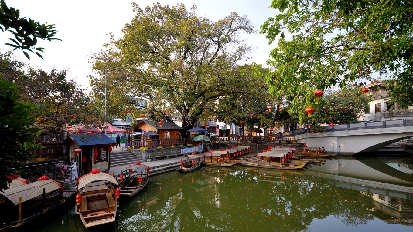  Panoramic view of Fengjian Water Town, showcasing its canals, old houses, and a stone bridge