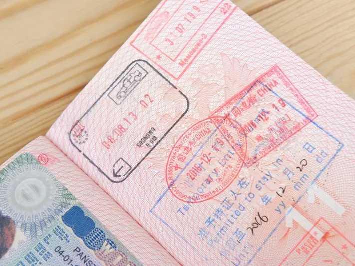Passport and Chinese visa documents with stamps