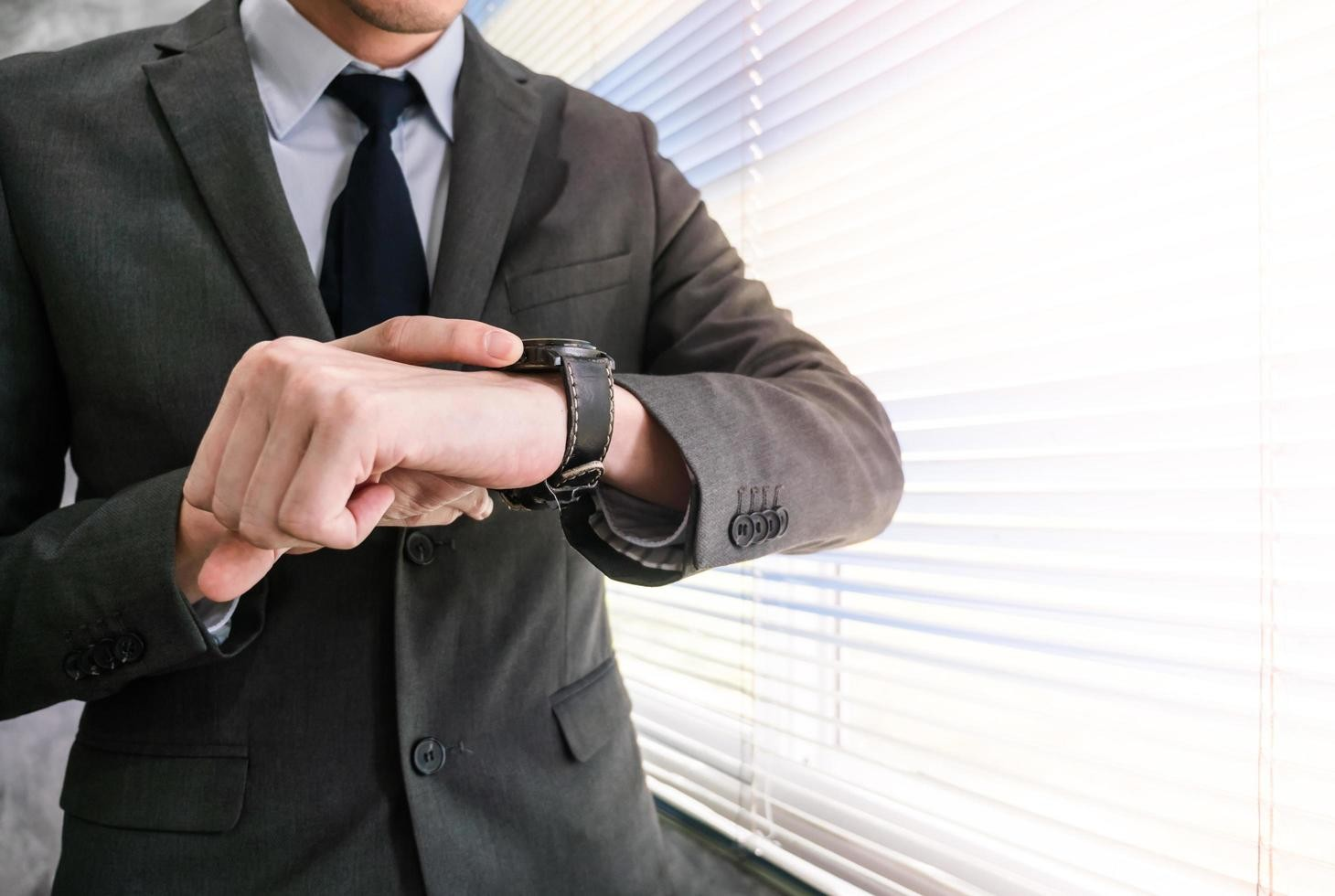 Person checking watch while waiting at meeting point