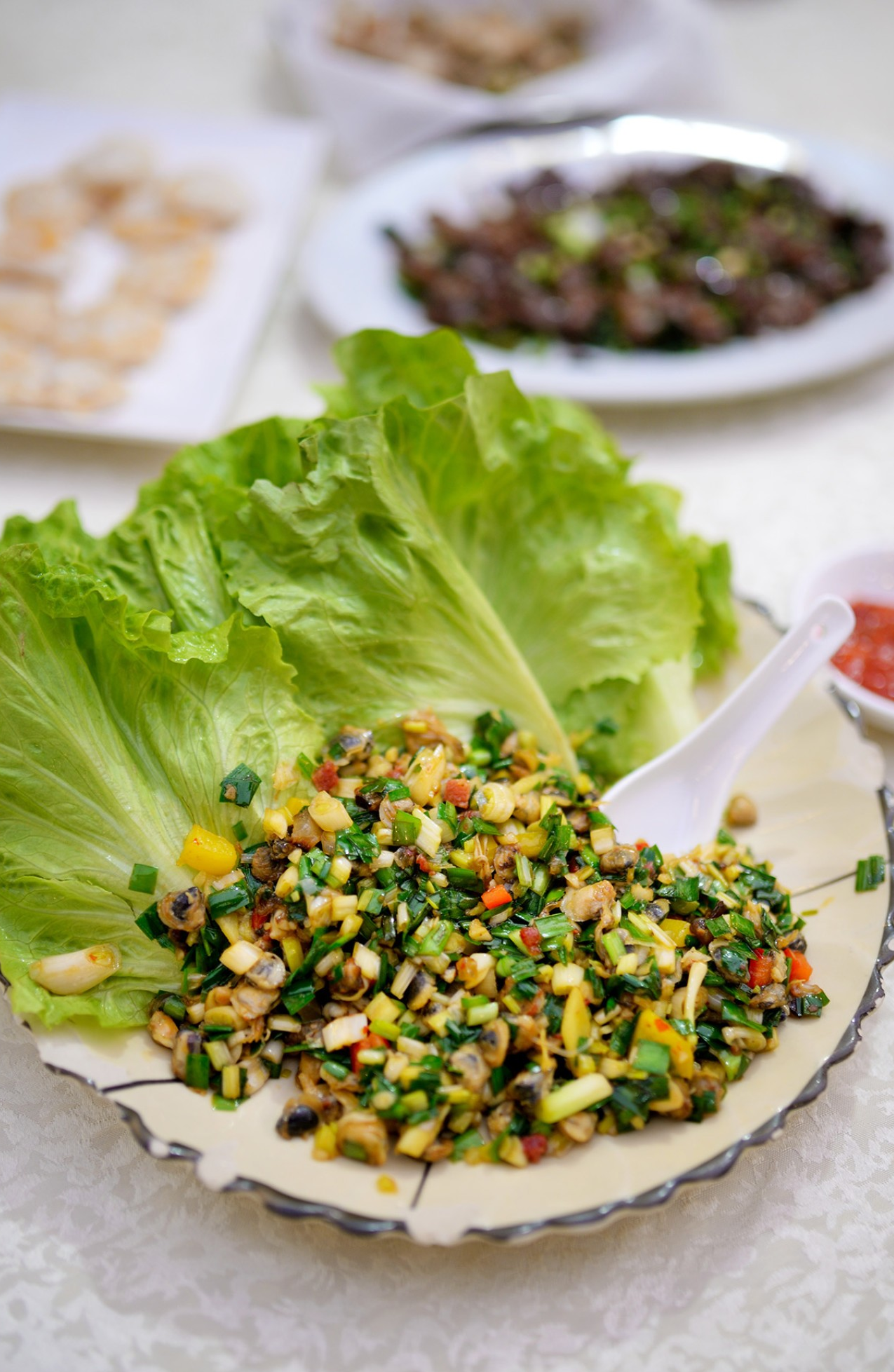  The colorful stir-fried filling for Clam Meat Lettuce Wraps, served with fresh lettuce