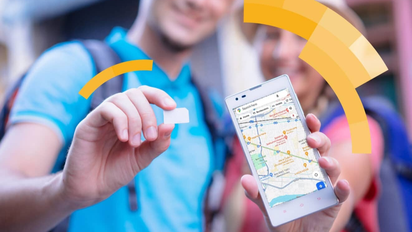 Tourist holding smartphone with local SIM card package