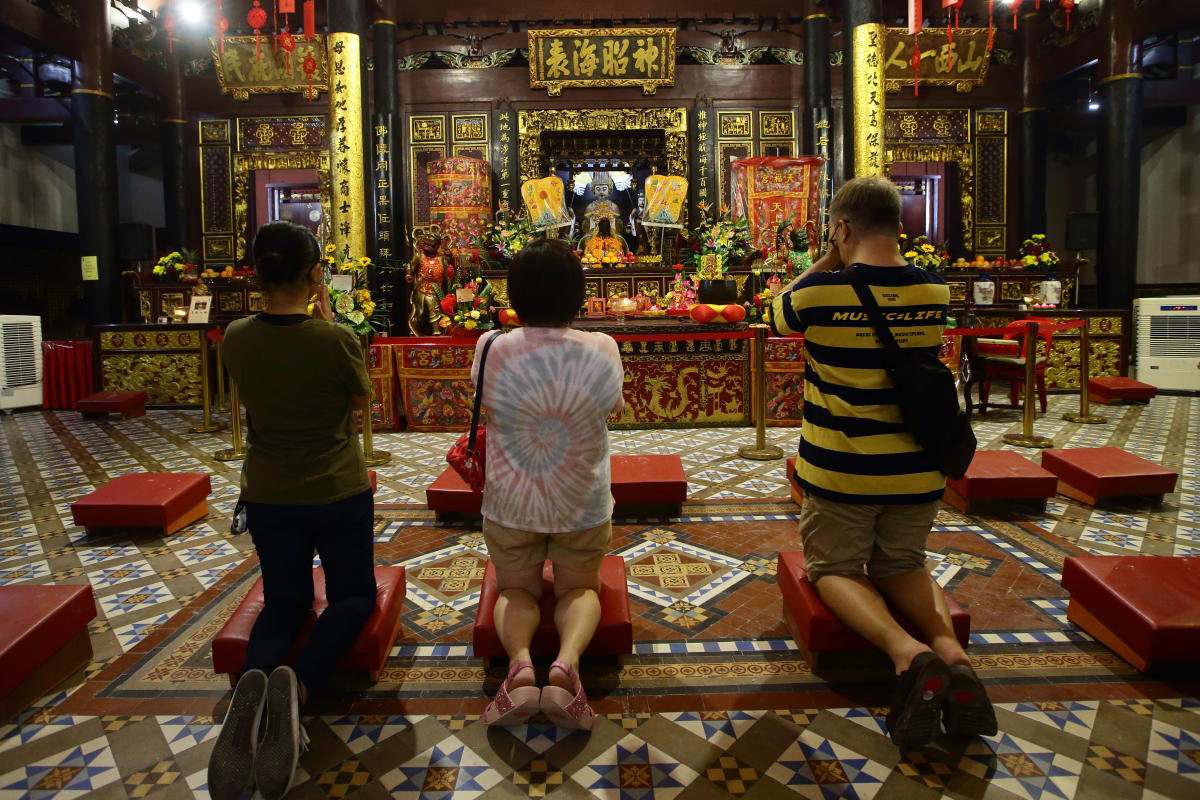 Traditional Chinese temple with visitors showing respectful behavior