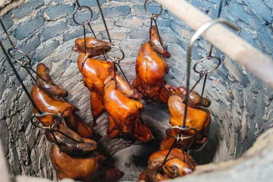  Traditional clay urns used for roasting geese, showcasing the cooking method