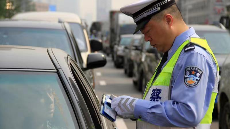 Traffic police checking documents at a roadside checkpoint in China