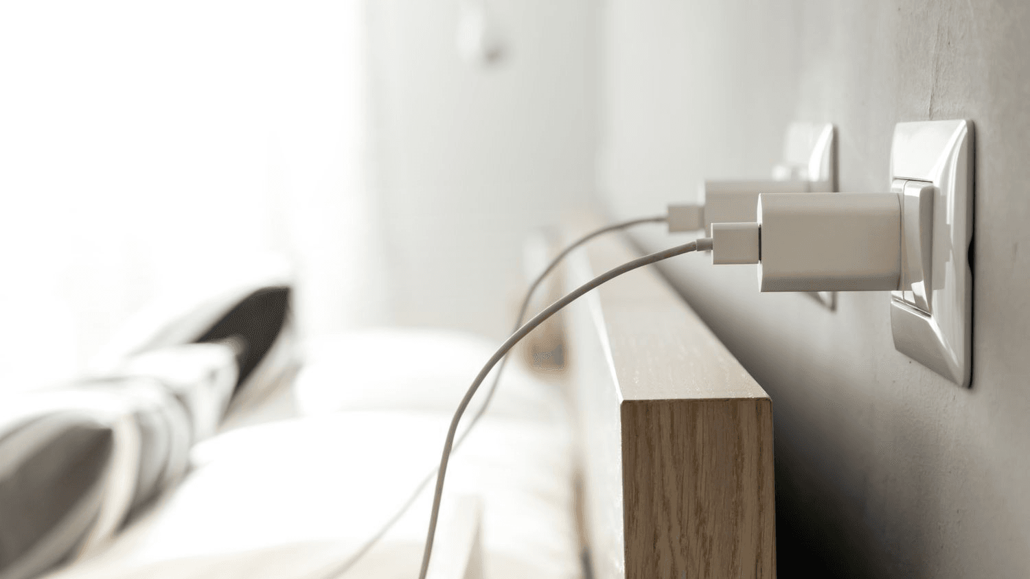 Traveler charging multiple devices in a hotel room