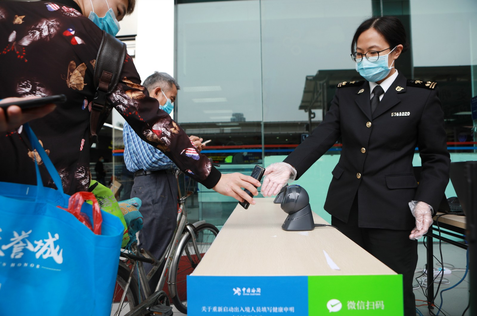 Traveler using smartphone with WeChat customs declaration app