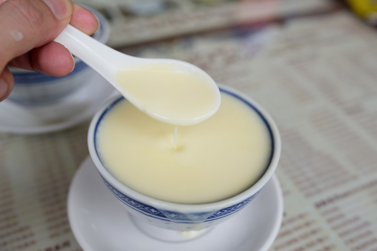  A bowl of Phoenix Milk, highlighting its rich, yellow, custardy texture.
