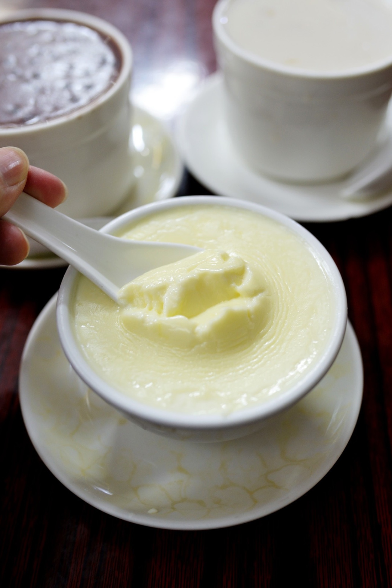  A close-up of the smooth, glistening Milk Egg Custard in a traditional bowl