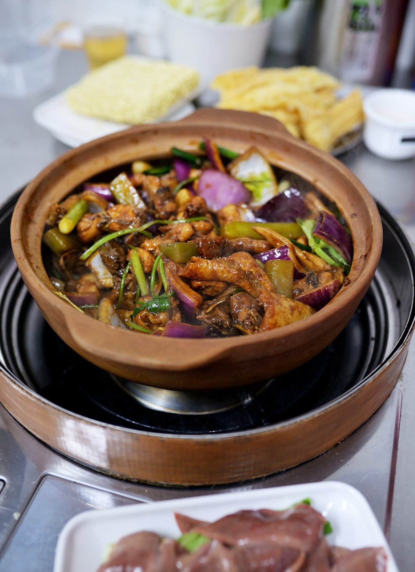 Chicken being stir-fried with Hu Xu Lao’s signature sauce before braising