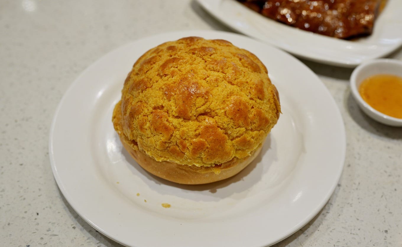 Freshly baked pineapple bun with melting butter inside
