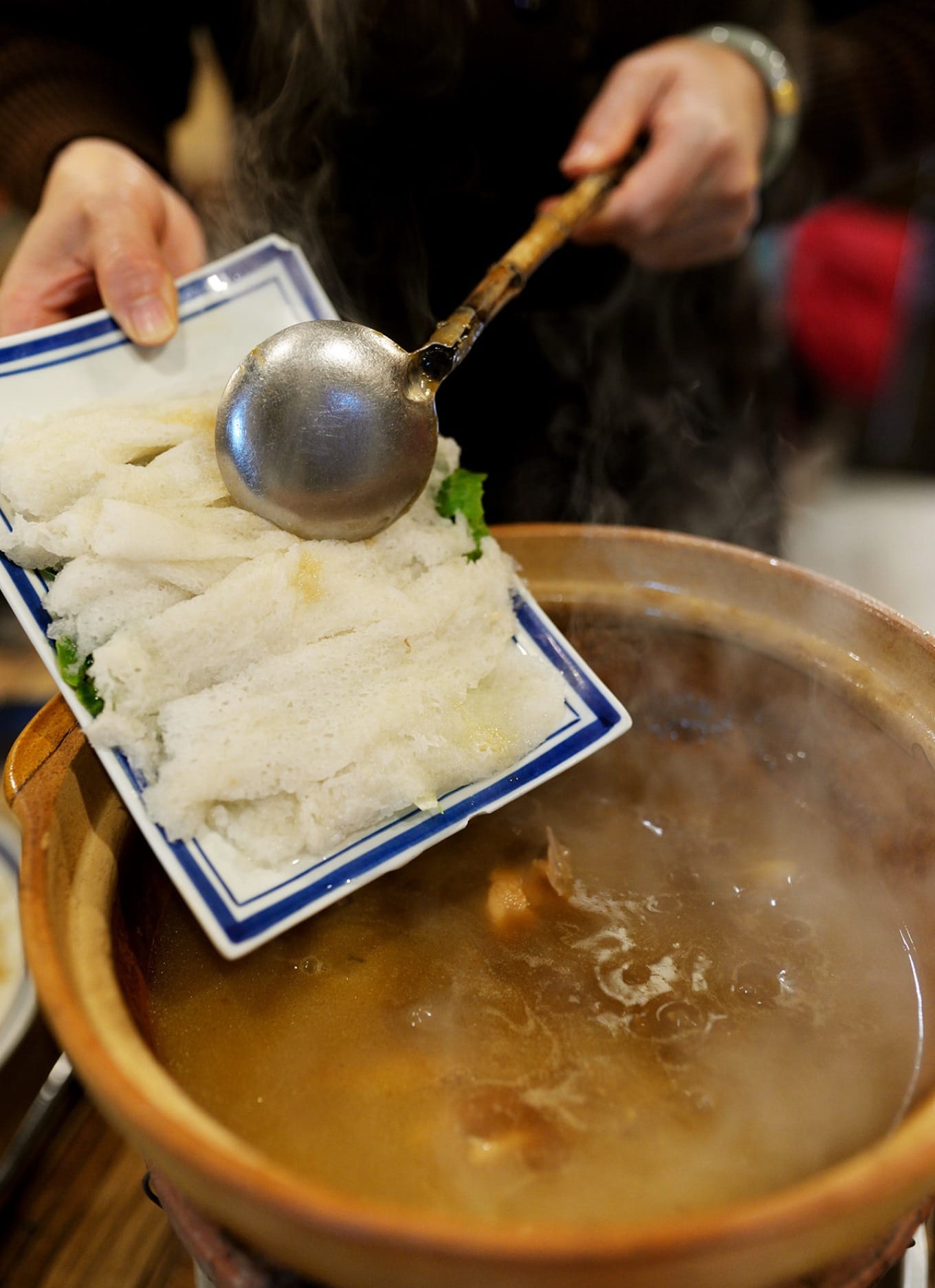Bamboo fungus added to simmering chicken claypot broth