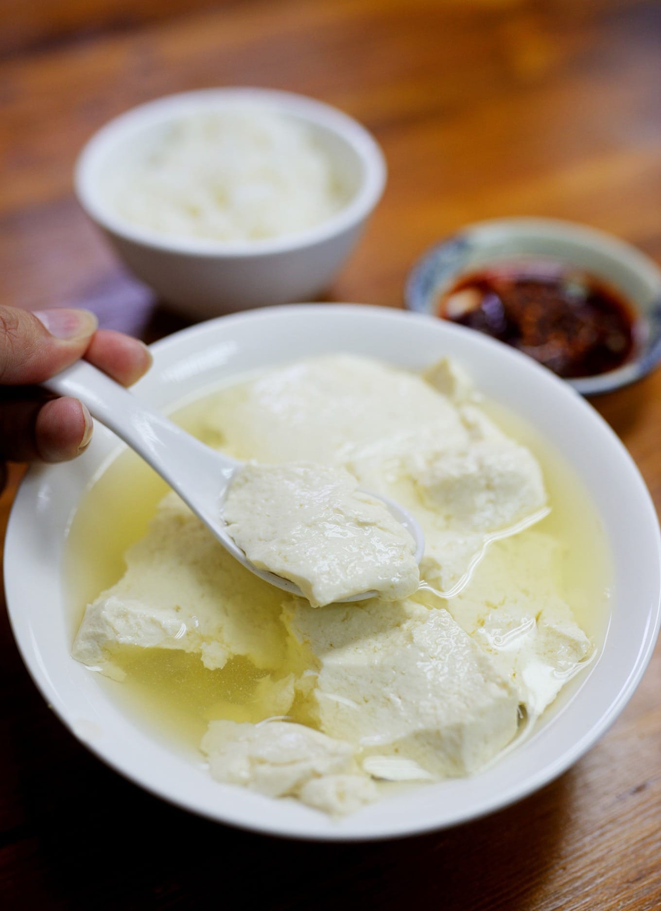 Traditional Sichuan-style douhua served with a bowl of white rice