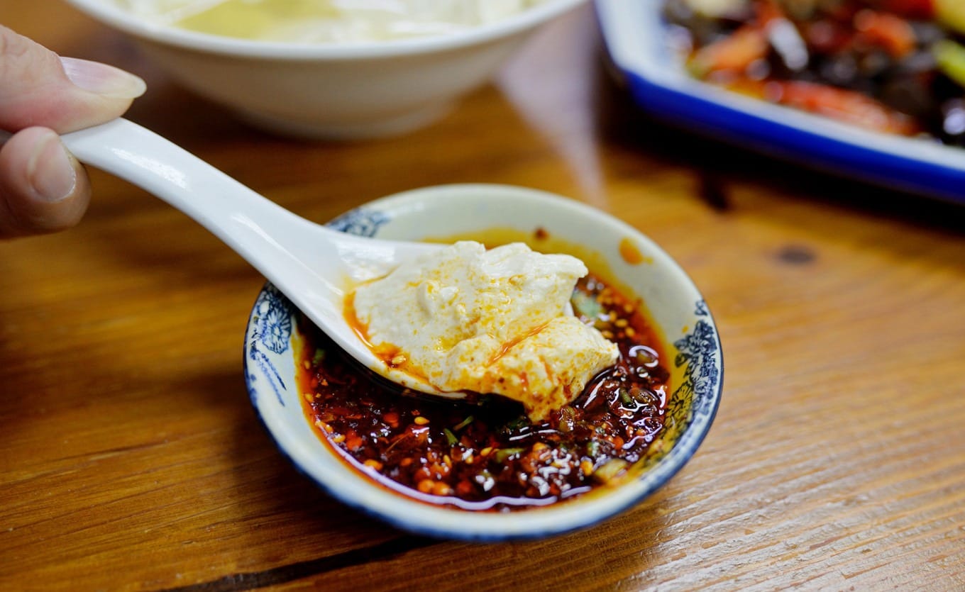 Douhua rice topped with spicy Sichuan chili and doubanjiang dipping sauce