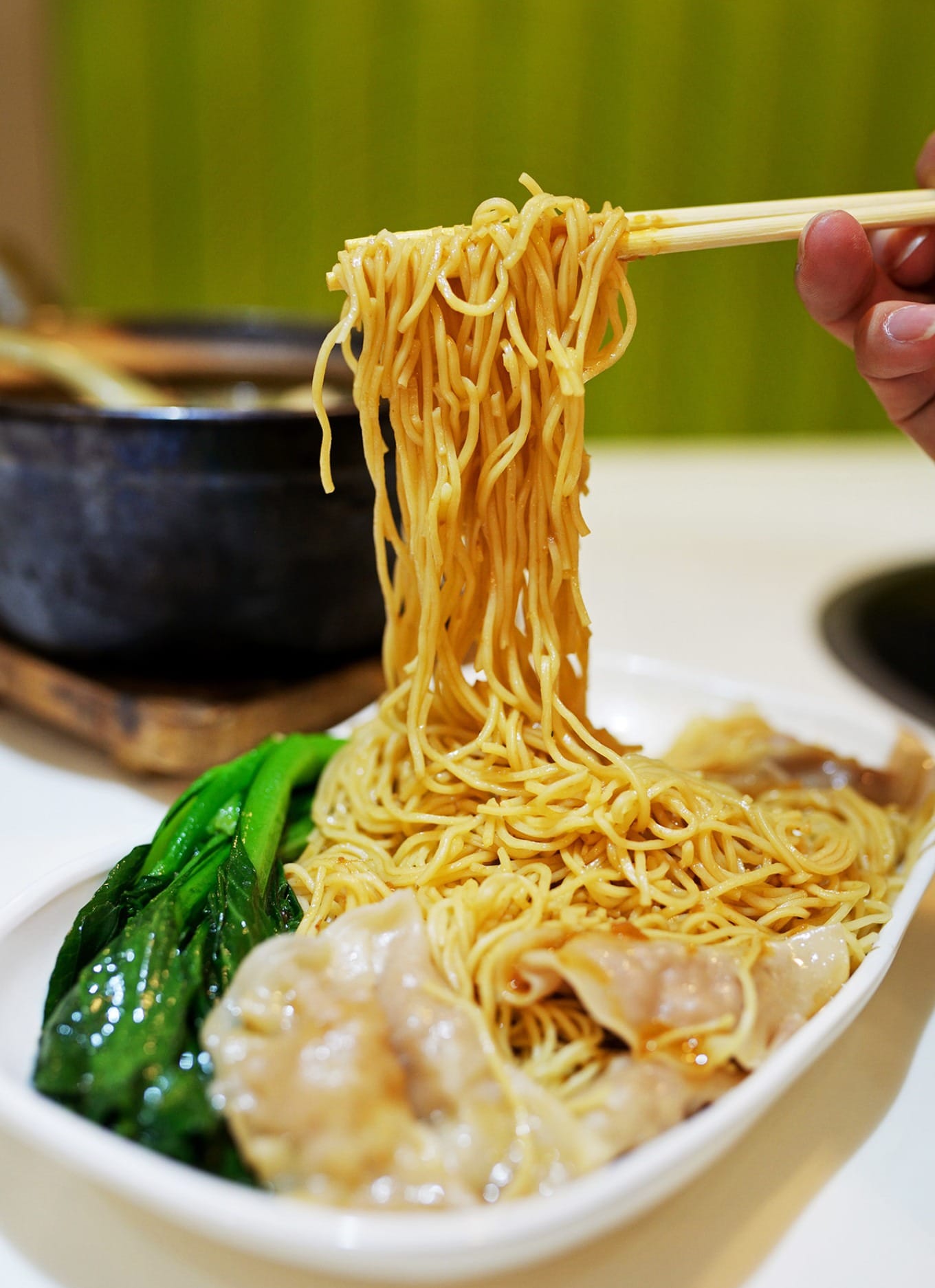 Fish skin dumplings served with oyster sauce tossed bamboo pole noodles