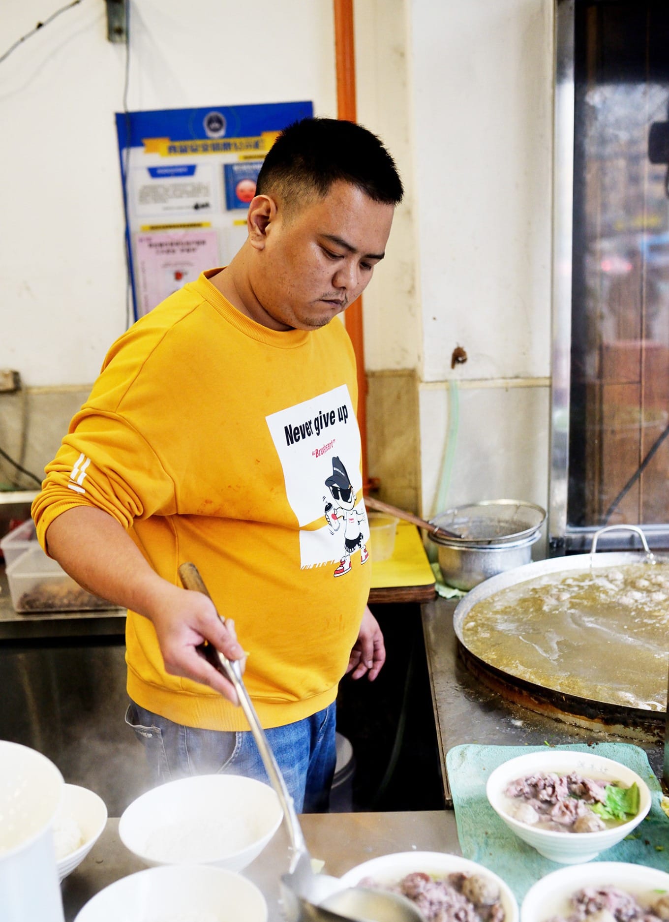 Thin Tongkeng-style guo tiao noodles being cooked fresh in broth