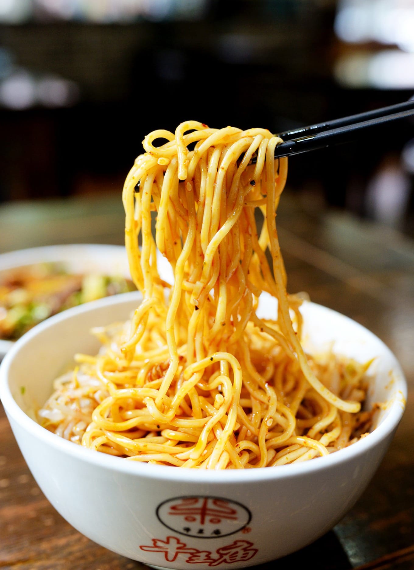 Mixed shredded chicken cold noodles showing glossy sauce and springy texture