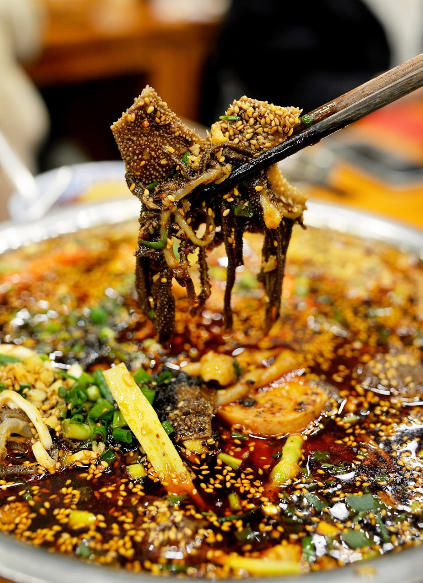 Close-up of mao roast duck with crispy skin and assorted spicy side dishes