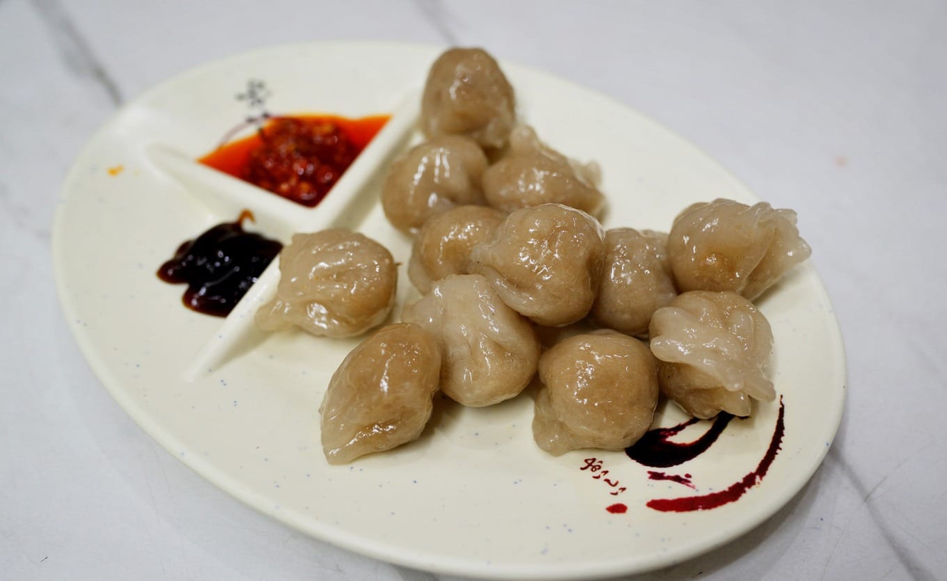 Cooked Haifeng Xiaomi dumplings showing translucent skins and savory filling