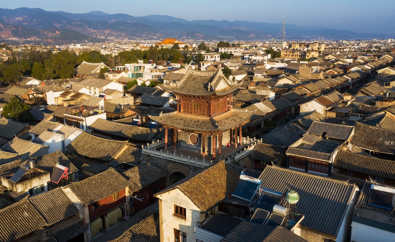 Aerial drone view of Xinggong Tower standing at the intersection of Weishan Ancient Town's four main streets