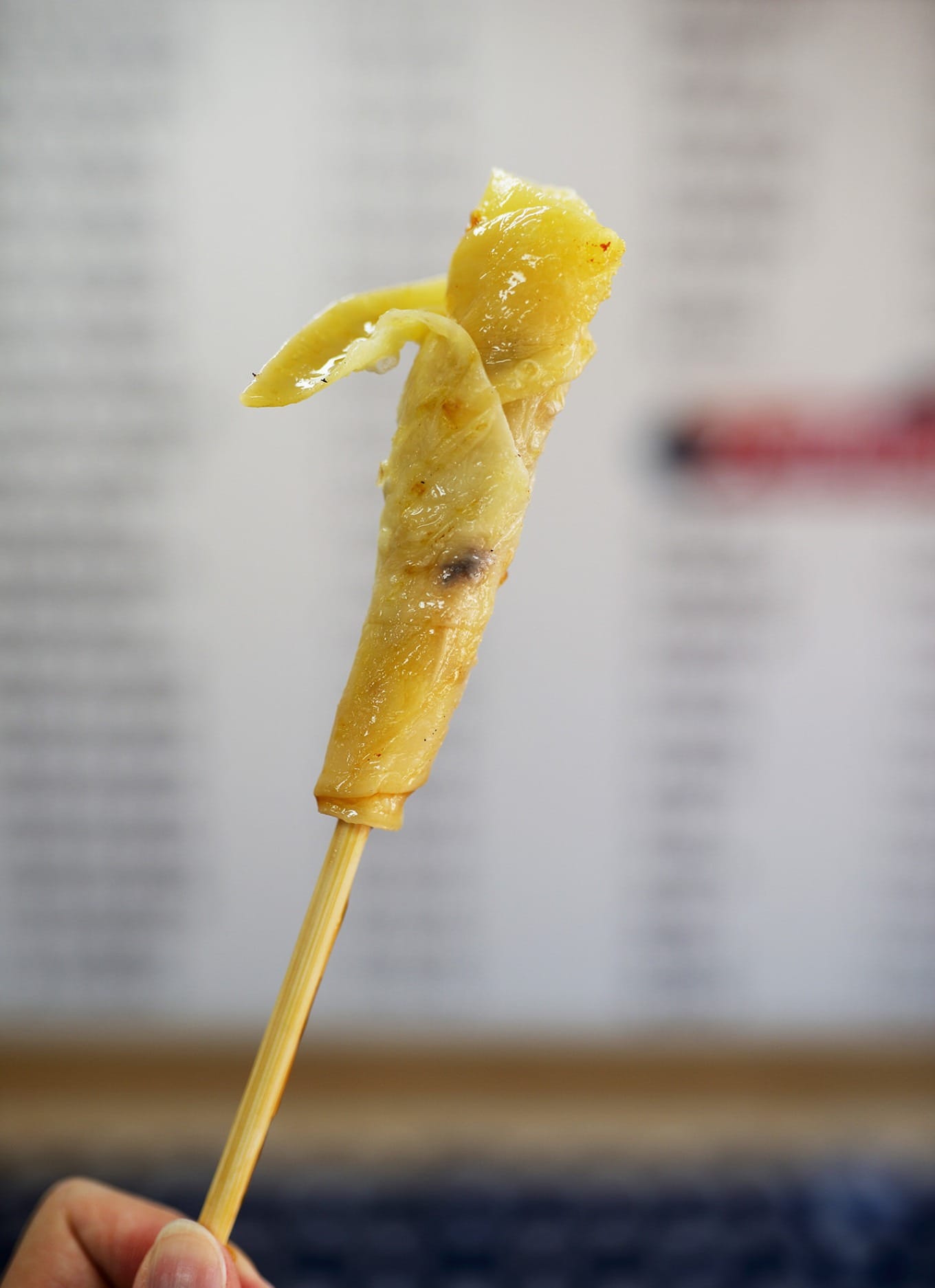 Grilled Rushan (milk fan) being rolled up with rose sugar