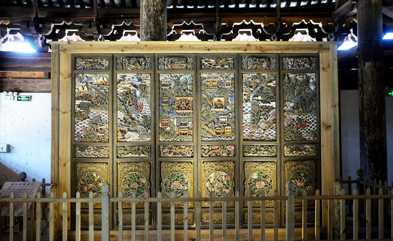 Detailed carving showing seasonal scenes on the Minglun Hall Partition Doors