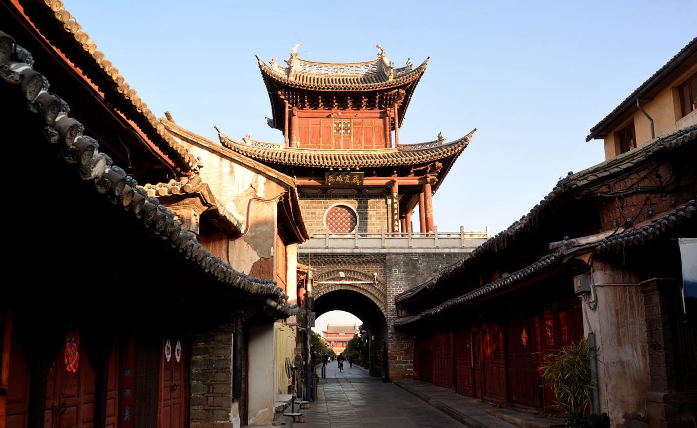 View looking through the arched passageway of Xinggong Tower, showing the intersection of streets