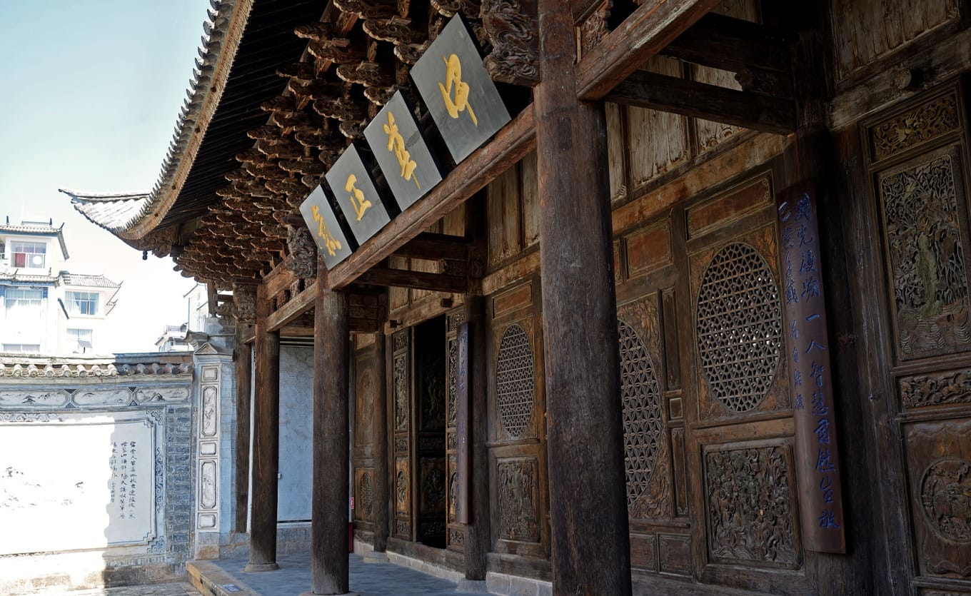 Detailed close-up of the carved Eight Immortals scene on a partition door