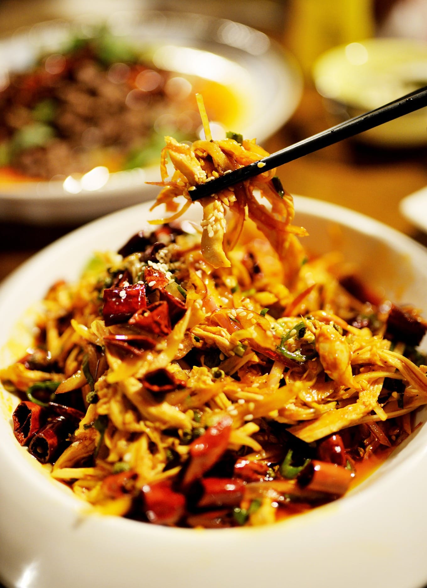 Sichuan-Style Spicy Chicken salad with vibrant red oil and herbs