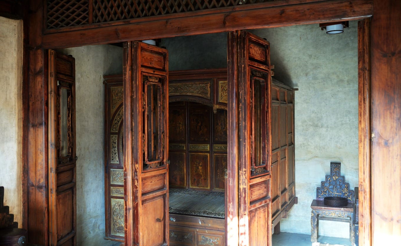Detailed wood carvings and architectural features in the courtyard