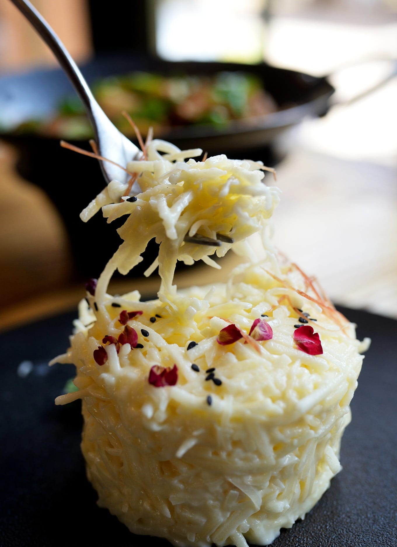 Close-up of Rushan Apple Tart dish showing shredded milk curd and apple strips
