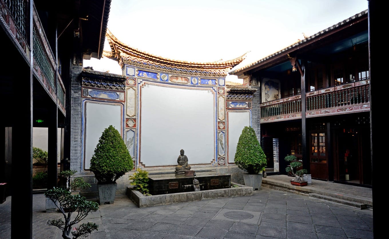 Interior view of the first courtyard at Xilin Yuan showing traditional Bai architecture
