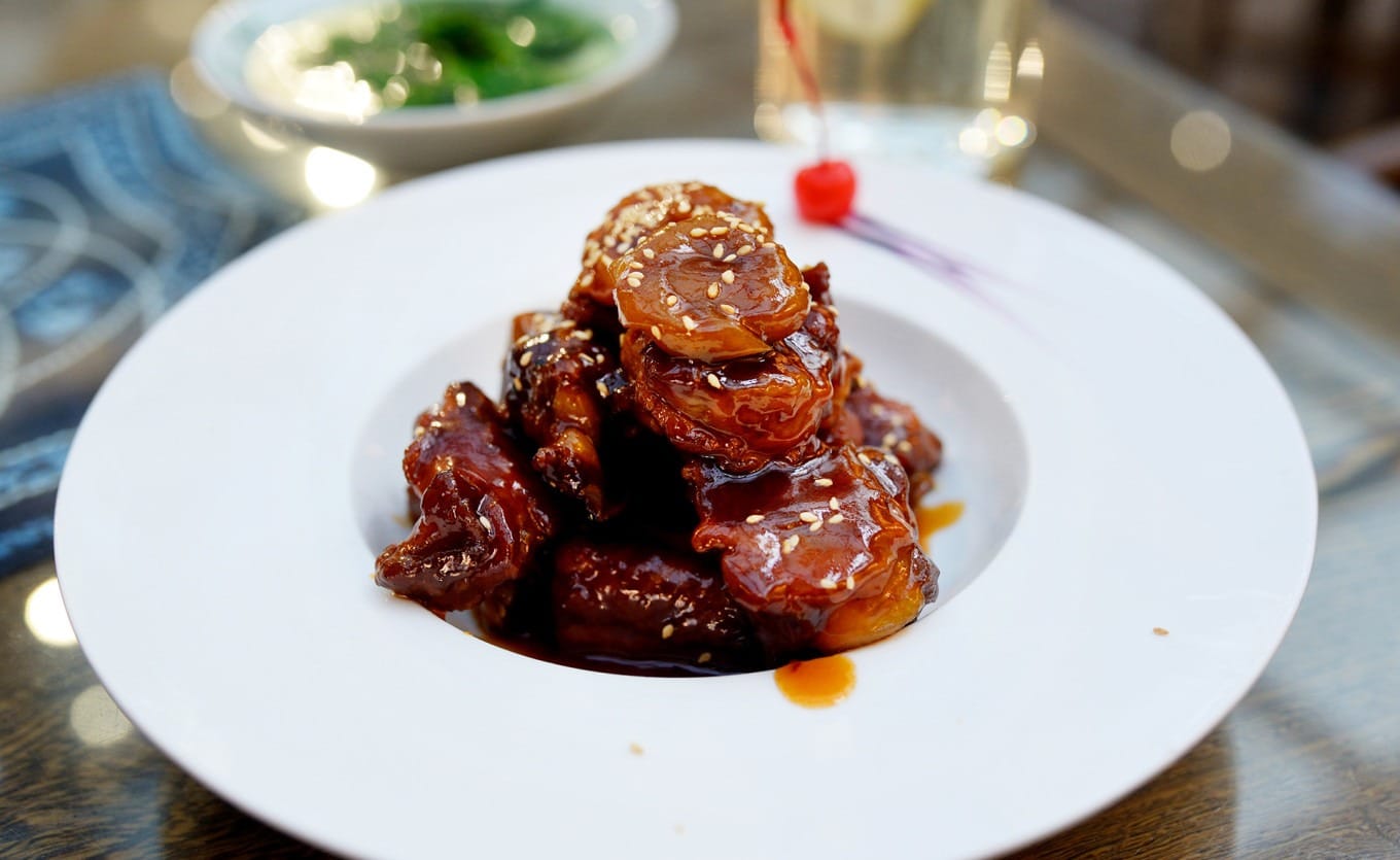 Close-up of the signature Caramelized Plum Ribs (Diao Mei Xiao Pai) dish
