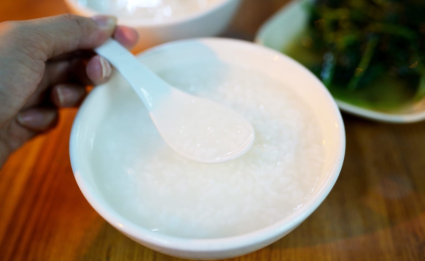 Bowl of traditional Teochew white porridge with distinct rice grains