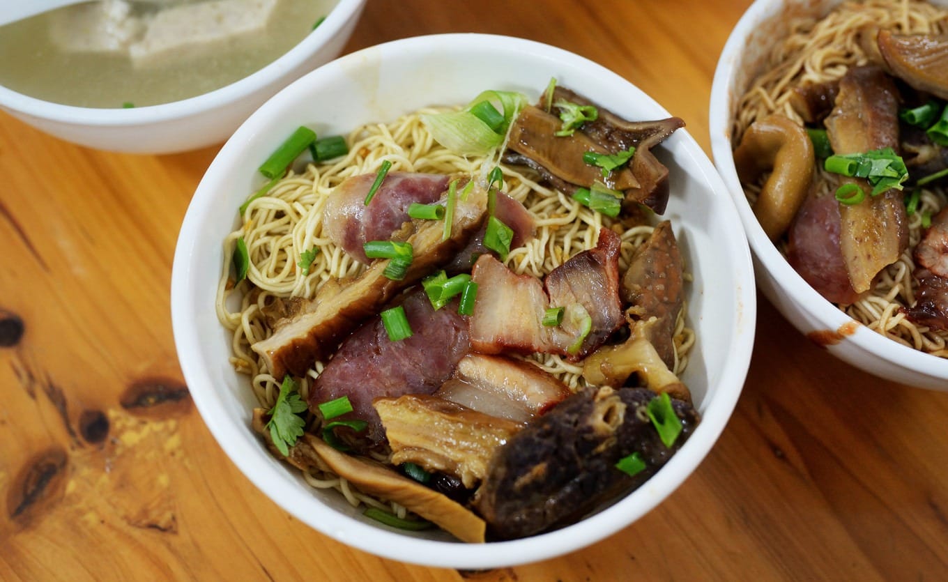 Assorted braised toppings including pork tripe char siu and Chinese sausage